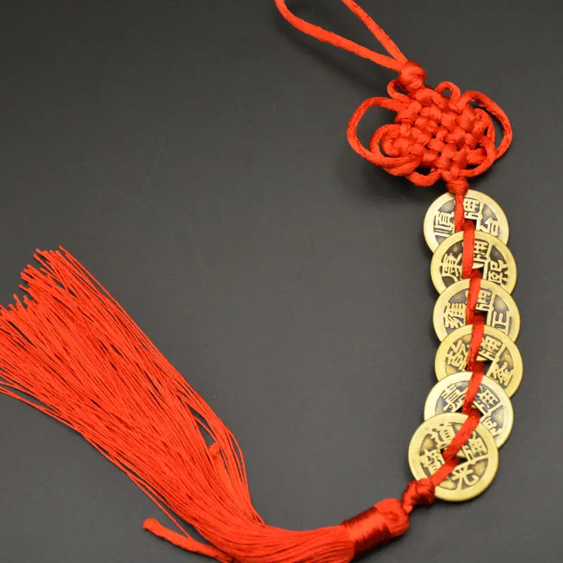 Orange thread charm featuring a copper coin and handwoven knot for Feng Shui