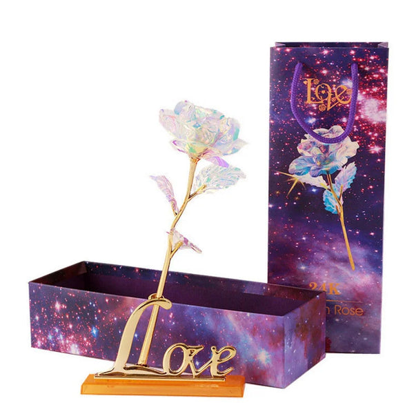 A gold foil artificial rose bouquet displayed in a purple box with glittery accents.