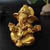 Golden handcrafted Buddha statue of an elephant sitting in a meditative pose