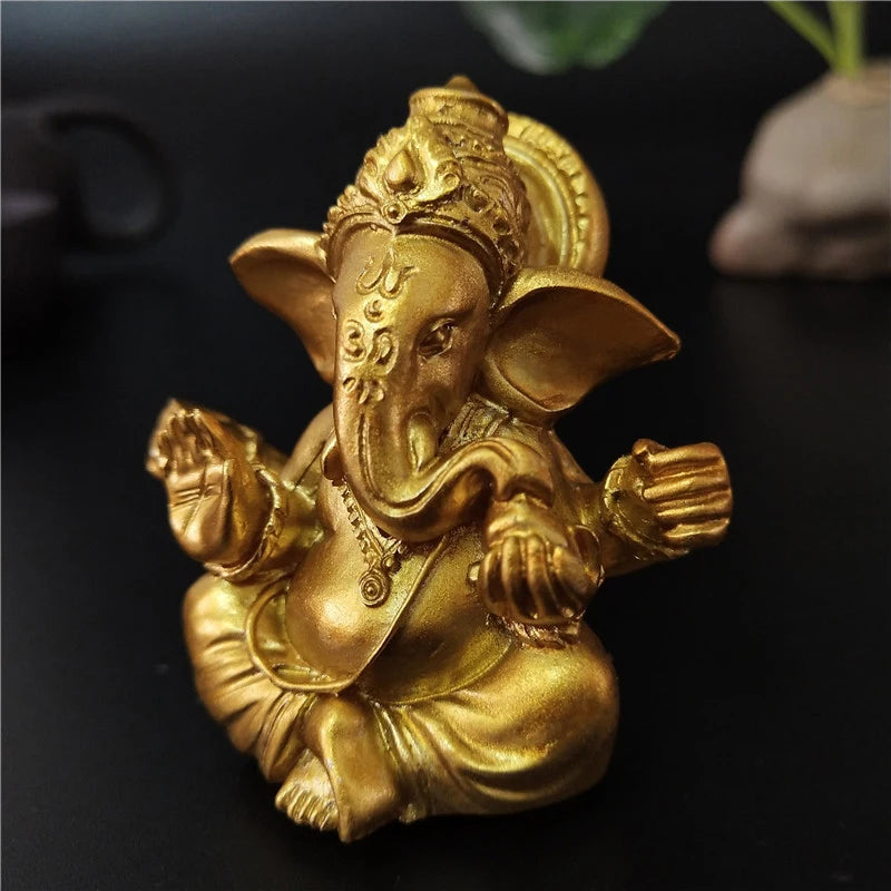 Golden handcrafted Buddha statue of an elephant sitting in a meditative pose