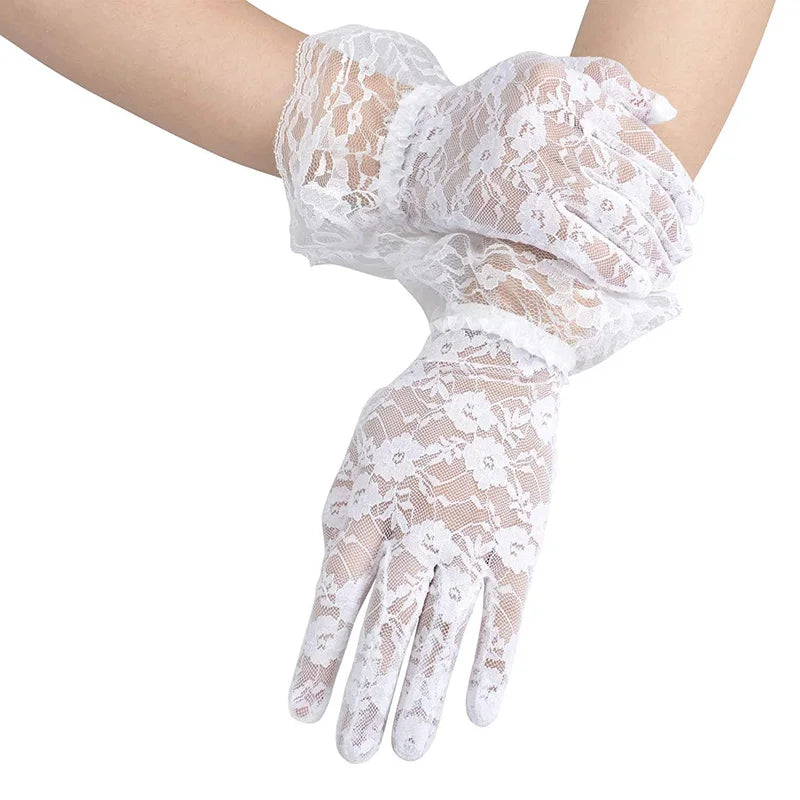 White sheer lace gloves worn on a hand, showing intricate floral patterns.
