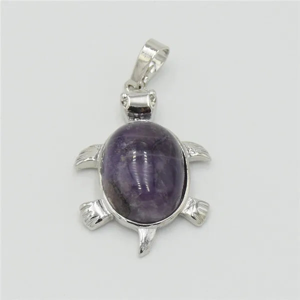 Silver pendant necklace featuring a polished purple amethyst stone shaped like an animal.