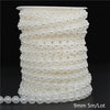 A spool of ivory pearl beads, measuring 9mm in diameter and 5 meters long per lot.
