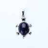 A silver pendant necklace featuring a polished, dark blue natural stone shaped like an animal.