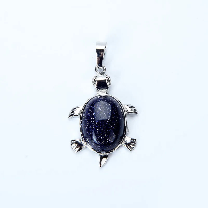 A silver pendant necklace featuring a polished, dark blue natural stone shaped like an animal.