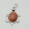 Silver pendant necklace featuring a polished reddish-pink natural stone shaped like an animal.