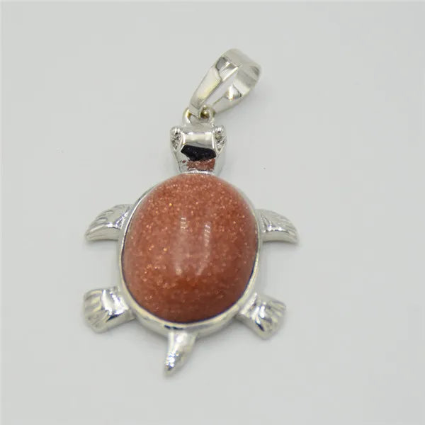 Silver pendant necklace featuring a polished reddish-pink natural stone shaped like an animal.