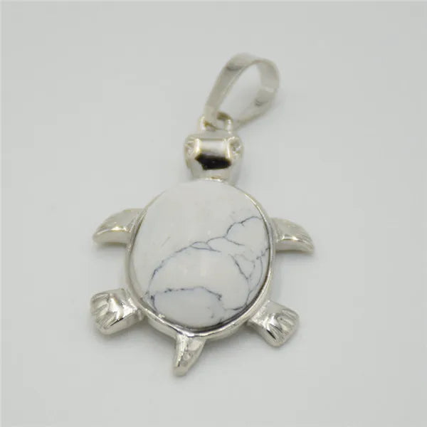 Silver pendant necklace featuring a polished white marble stone shaped like an animal.