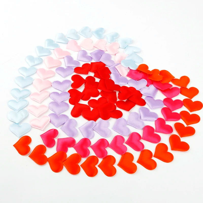 A heart-shaped confetti display in various pastel and bright red colors arranged in a heart shape.
