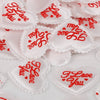 White heart-shaped sponge confetti with red text I love you for weddings and celebrations