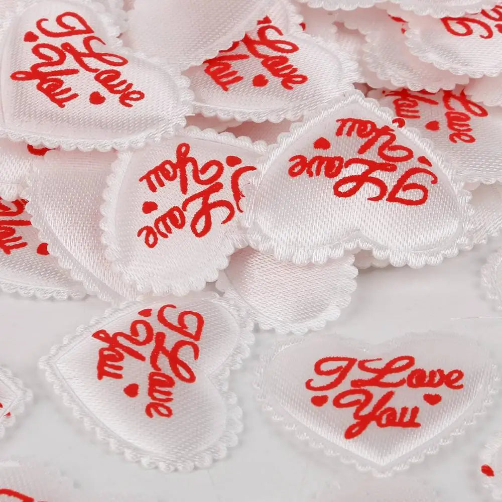 White heart-shaped sponge confetti with red text I love you for weddings and celebrations