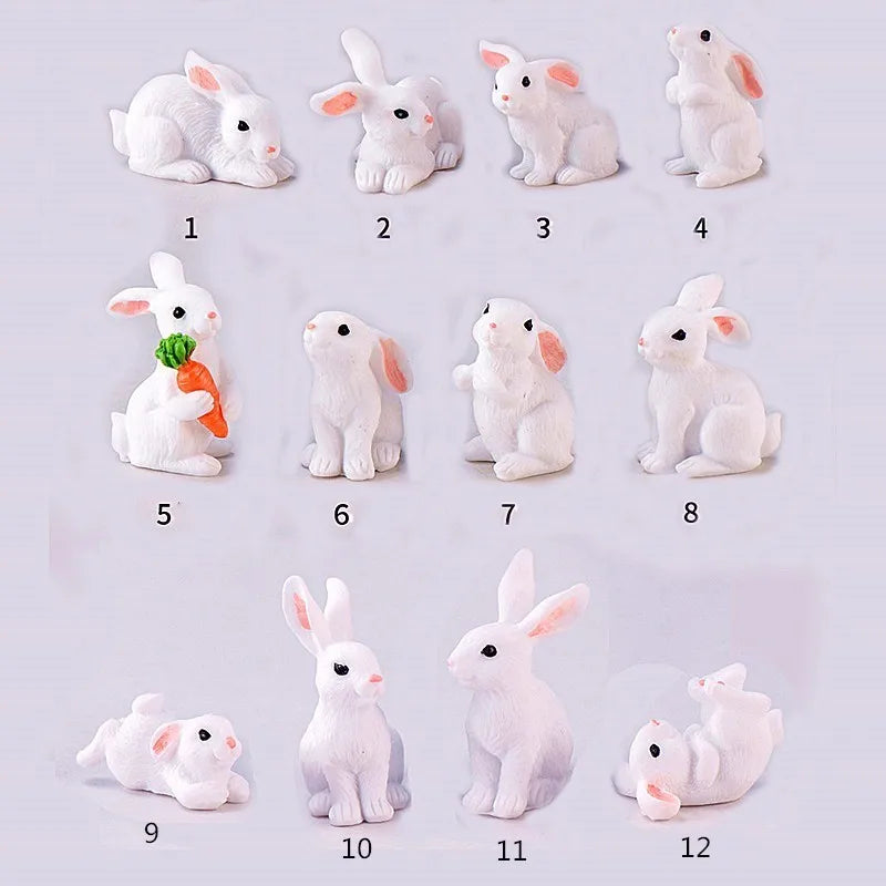 Twelve miniature white rabbit figurines arranged in a grid display.
