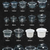 A collection of clear disposable dessert cups with lids shown in various sizes and angles.
