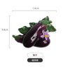 A set of realistic fruit and vegetable fridge magnets featuring a purple eggplant with a purple flower and green leaves.