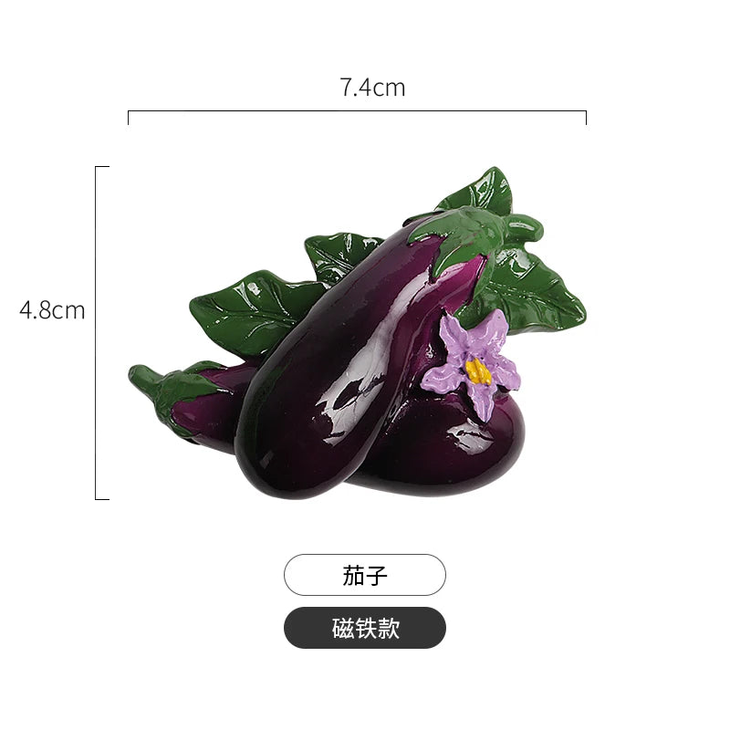 A set of realistic fruit and vegetable fridge magnets featuring a purple eggplant with a purple flower and green leaves.