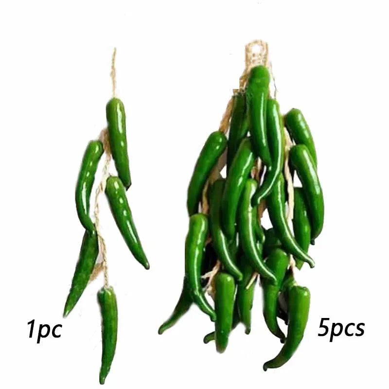 A bundle of five bright green artificial fruits or vegetables on natural twine.