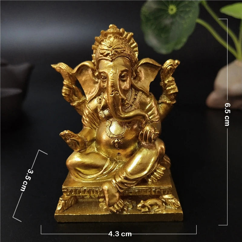 Gold Ganesha statue handcrafted resin figurine sitting on a base