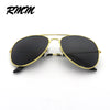 Classic gold-rimmed pilot sunglasses with black mirror lenses shown against a white background.