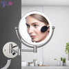 Wall-mounted LED makeup mirror with a makeup brush and magnifying lens
