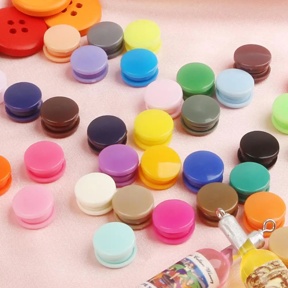 Assorted snap buttons in various colors including orange, yellow, green, blue, pink, and brown for crafting