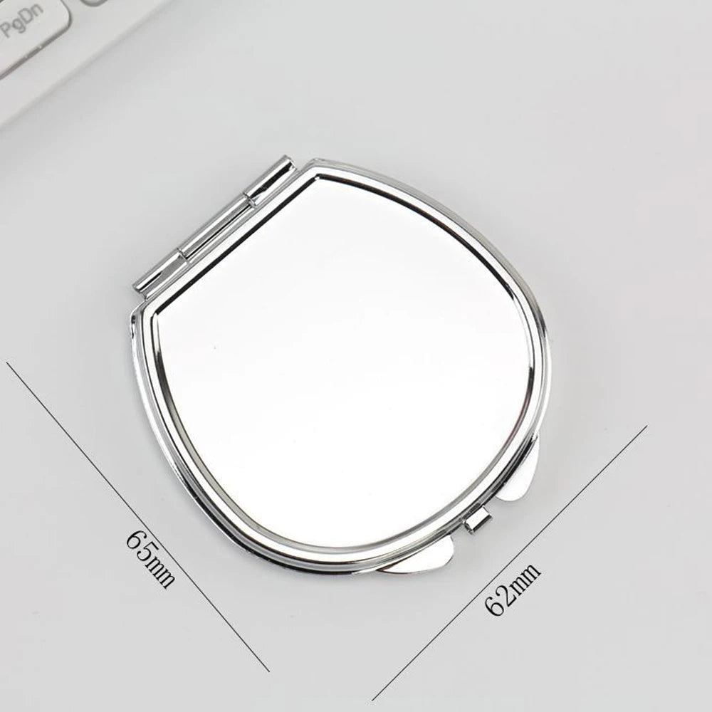 A silver mini double-sided folding makeup mirror shown from above with dimensions marked.