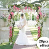 A white wedding arch decorated with pink and green floral vines and greenery for outdoor events