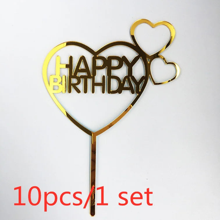 A set of ten gold acrylic love heart birthday cake toppers shaped like a heart with the words HAPPY BIRTHDAY inside.