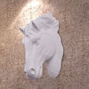 White 3D resin horse head wall sculpture mounted on a textured beige wall.