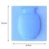 A light blue flexible self-adhesive wall flower vase with a rounded body and neck.
