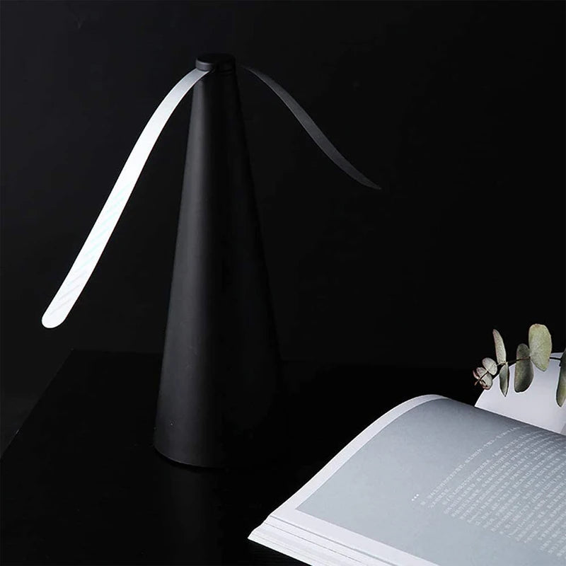 A black automatic electric fly repellent fan with a white, curved blade is shown against a dark background.