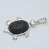 Silver pendant necklace featuring a polished black natural stone shaped like an animal.