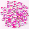 A collection of pink and clear glass rhinestones in various shapes and sizes.