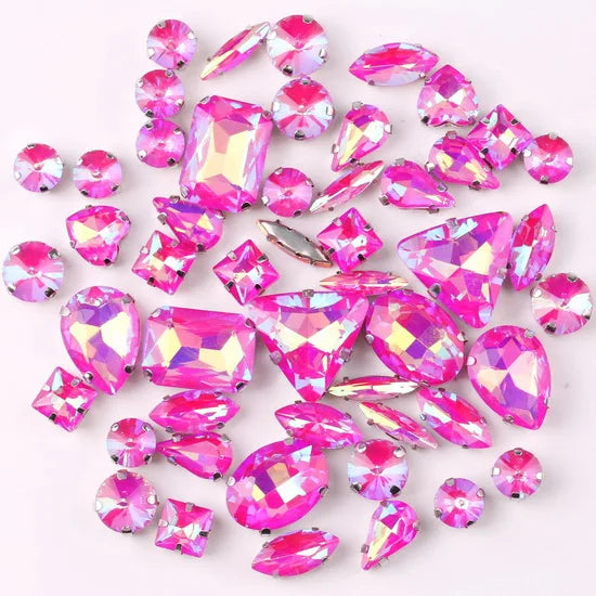 A collection of pink and clear glass rhinestones in various shapes and sizes.