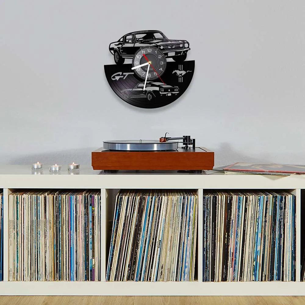 A wall clock featuring a black sports car design with a racing theme and a vinyl record display.