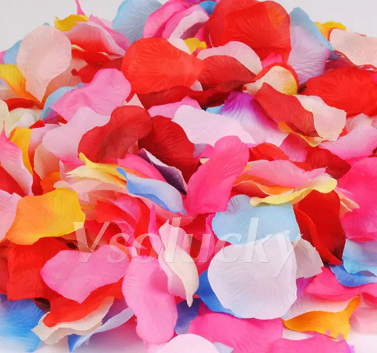A colorful mix of silk rose petals in shades of pink, red, blue, and orange.