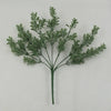 A sprig of artificial green fern leaves and fronds on a thin stem.