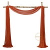 Orange sheer chiffon fabric drape used as a backdrop for weddings and events