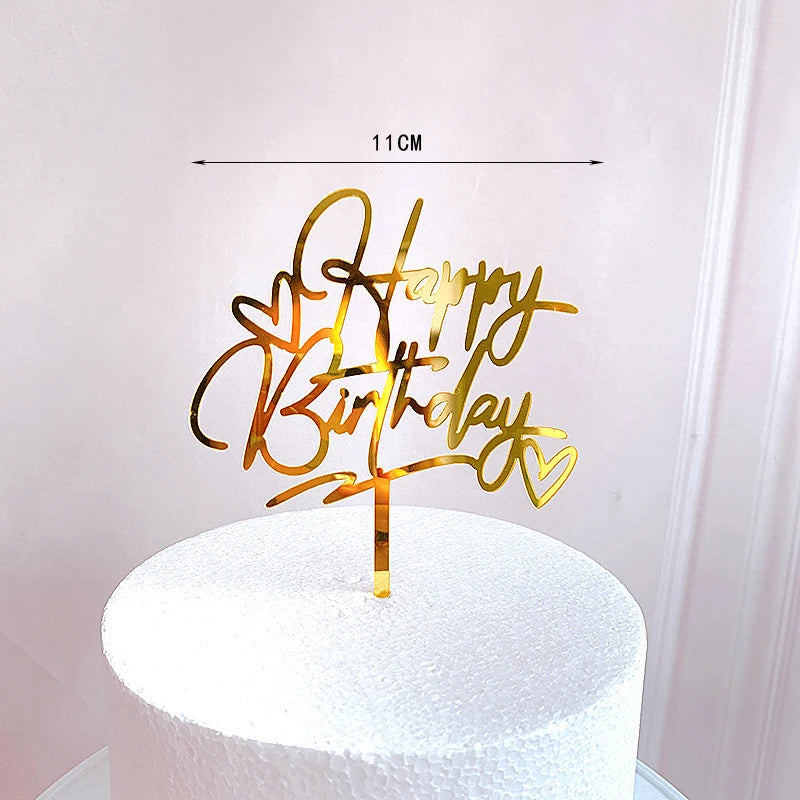 Rose gold acrylic happy birthday cake topper on a white cake.