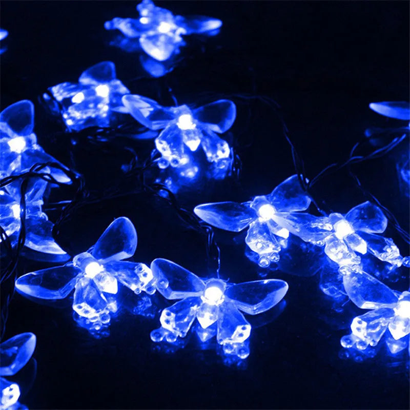 Blue solar decorative string lights illuminating dark background.