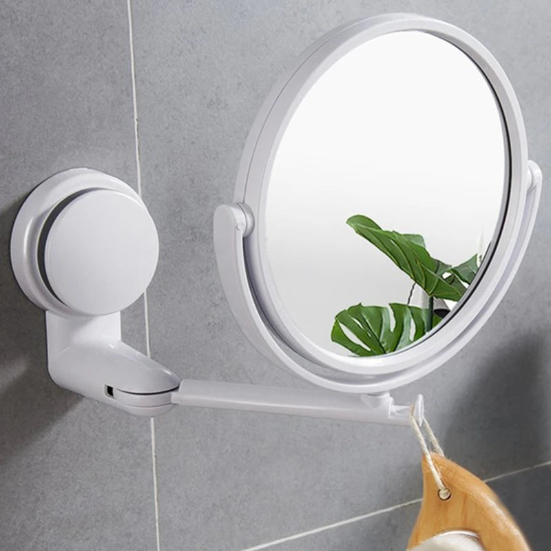 A white 360° rotating wall-mounted vanity mirror with an HD magnification lens mounted on a tile wall.