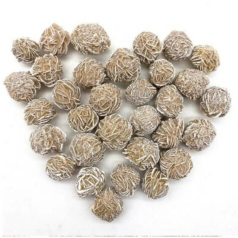 A collection of natural desert rose selenite stones in various shades of beige and gray.