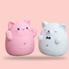 A pink cartoon cat figure and a white bear figure are displayed against a light background.