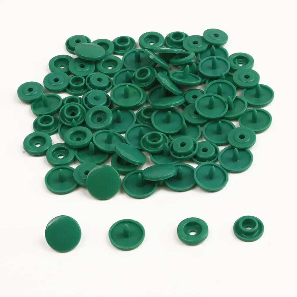 A pile of assorted green snap buttons, measuring 12mm and 10.5mm, for crafting.