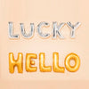 Silver and gold foil letter balloons spelling LUCKY HELLO