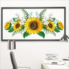 A framed floral print featuring yellow sunflowers and green foliage for home decor.