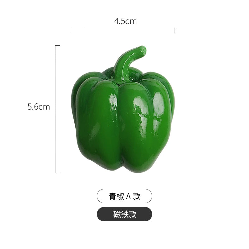 A green bell pepper shaped fridge magnet with a stem, shown against a white background.