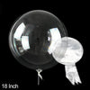 A clear PVC party balloon is shown against a black background, displaying its reflective surface and attached string.