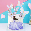 A white cake decorated with purple and gold butterfly toppers, featuring a small figure in a purple dress.
