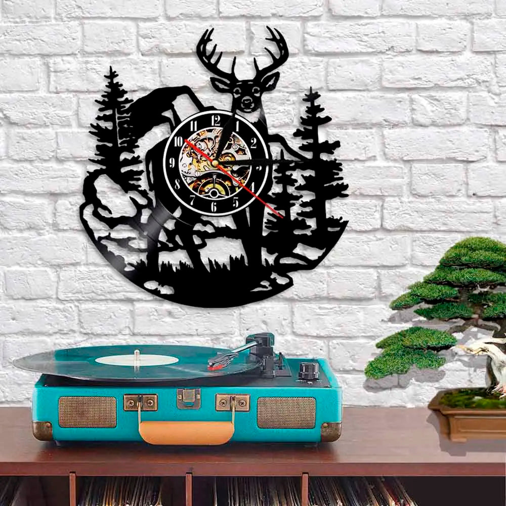 A black silhouette of a deer head and pine trees forms a wall clock design.