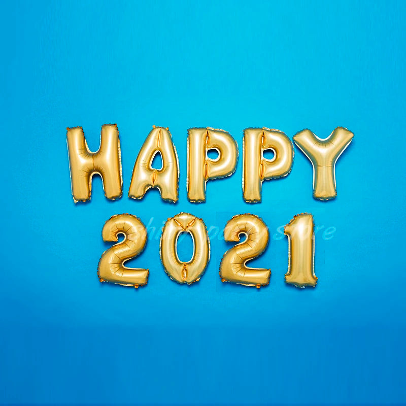 Gold foil letter balloons spelling HAPPY 2021 on a blue background